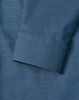 A detailed close-up of a blue men's button-up shirt featuring a pin dot pattern and a cuff.