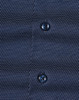 Men's long-sleeve button-up shirt in navy with a pin dot pattern and two dark buttons. Features subtle texture.