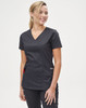 A solid black short-sleeve scrub top worn by a smiling woman, featuring a v-neck and pockets.
