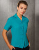 A teal short sleeve overblouse with a button-up front and a pocket, featuring a collar.