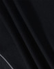 A close-up of a textured black fabric, featuring folds and draping typical of a polo shirt material.