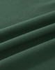 A close-up view of soft, dark green cotton fabric, featuring gentle folds and a smooth texture.