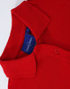 A red ladies cotton stretch polo shirt with a collar and buttons, featuring a logo inside the collar.