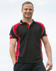A men's polo shirt in black with red accents and a logo. The model is smiling and standing outdoors.