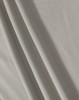 A textured, light grey fabric featuring soft folds. The material is suitable for polo shirts and has a subtle sheen.