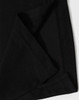 A close-up of black fabric showcasing a folded corner, featuring stitching details and a hidden pocket.
