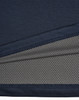 A close-up of a navy blue men's polo shirt featuring a textured fabric with a contrasting inner layer.