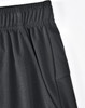 A close-up of black bamboo charcoal sports shorts featuring an elastic waistband and side pocket.