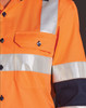 An orange work shirt with reflective silver stripes, featuring a pocket and black sleeves. It includes a logo.