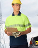 A high-visibility unisex short-sleeve polo in bright yellow and navy, featuring reflective stripes and a chest pocket.