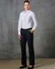 A model wearing ladies' permanent press pants in black, paired with a light blue button-up shirt, standing against a textured backdrop.