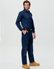 A man poses wearing dark blue heavy duck weave work pants with pockets, complemented by a matching shirt and boots.
