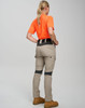 Work pants in light beige with grey accents, worn by a person in an orange shirt, facing away from the camera.
