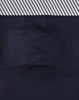 A pair of navy blue unisex cotton stretch ripstop segmented work pants with a patterned waistband and a logo.
