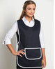 A navy blue ladies' smock apron with white trim and a front pocket, featuring a model wearing it.