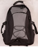 A grey and black backpack with exterior mesh pockets and bungee cord detailing. It features a logo on the front.