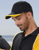 A red cap with a peak and contrasting black and white accents, featuring a logo.