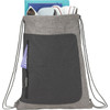 A grey drawstring bag with a front pocket, containing various items, and featuring a logo.