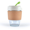 A reusable coffee cup with a cork band and a white lid featuring a green straw. The cup is made of transparent glass.