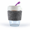 A reusable coffee cup with a clear base, grey felt band, and a cream-colored lid with a purple straw.