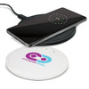 A wireless charger in white with a logo, featuring a smartphone displaying charging status on its surface.