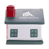 A house-shaped stress reliever in white with green windows and a red chimney, featuring a logo on the front.