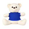 A plush toy bear in cream colour, wearing a blue t-shirt, with large black buttons for eyes and a friendly expression.