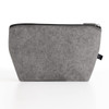 A grey felt pouch with a zipper, featuring a logo. Ideal for storing toiletries and accessories.