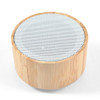 A bamboo Bluetooth speaker featuring a circular design with a perforated upper surface.