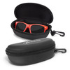 A black hard-shell sunglass case with a zipper, housing bright red sunglasses inside.