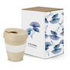 A drink bottle in a natural colour with a white silicone band, packaged in a decorative box featuring floral designs.