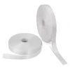 Two rolls of 25mm wide personalised ribbon in white, one partially unrolled. One roll has a logo.