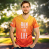 A men's performance v-neck t-shirt in shades of orange and yellow, featuring a logo and bold graphic design.