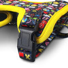A pet harness in black with bright, colourful patterns and yellow accents, featuring a plastic buckle.