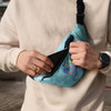 A full-colour Glastonbury belt bag in blue, features a front zip pocket and includes a logo.