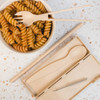 A Ramen Cutlery Set featuring bamboo fork, spoon, chopsticks, and a cleaning brush, presented with a bowl of fusilli pasta.