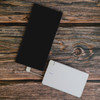 A white Arya 10,000mAh power bank with a black device beside it, featuring a cable connected to the white power bank.