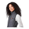 A woman with curly hair wears a black insulated puffer vest, featuring a logo on the chest.