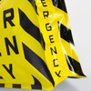 A large foil flat bottom pouch in bright yellow and black with a logo. It features a cautionary pattern.