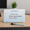 A whiteboard desk sign in light blue with a black marker, featuring a to-do list in black writing.