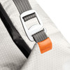 A cooler bag in light grey with a patterned surface, featuring a silver buckle and an orange branding tag.