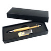 A black gift box containing a wooden pen and a metal USB drive with a logo.