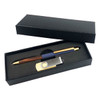 A gift set featuring a gold-accented pen and a silver USB drive in a black presentation box.