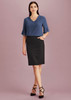 A model wearing a women's pencil skirt in black paired with a blue top, featuring a pocket and stylish heels.
