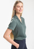 A women's short sleeve button-up shirt in a soft green colour, featuring a collar and a relaxed fit.