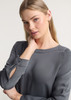 A grey women's Madison boatneck top with long sleeves and button detailing on the cuffs.