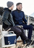 A unisex 1/2 zip pullover in navy and grey, worn by two men sitting outdoors with a drink bottle and a cooler.