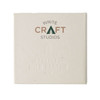 A square, off-white notepad with subtle embossed text, featuring a logo and made from recycled materials.