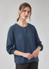 A women’s long sleeve blouse in navy blue with a round neckline and keyhole detail. Features a relaxed fit.