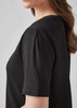A black short sleeve blouse with a ruché texture and puffed sleeves, featuring a simple, elegant design.